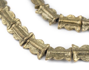 May include: A gold necklace made of intricately designed metal beads. The beads are connected by a thin string and have a textured, ornate pattern.