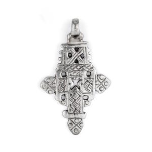 May include: A silver-toned pendant in a cross shape, featuring intricate geometric patterns and small black accents. The pendant has a loop at the top for a chain and is likely made of metal. The design is detailed and symmetrical.