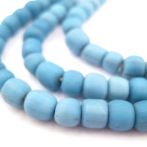May include: A strand of light blue glass beads. The beads are round and have a matte finish.