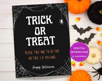 May include: A black Halloween sign with white text that reads "TRICK OR TREAT". The sign also says "PLEASE TAKE ONE TO BE FAIR OR TAKE 2 IF YOU DARE" and "Happy Halloween". The image includes pumpkins, bats, and spiders.
