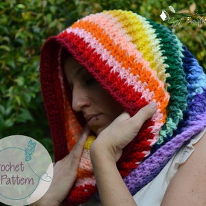 May include: A rainbow crochet hooded cowl with a textured stitch pattern. The cowl is made with a variety of colors, including red, orange, yellow, green, blue, and purple.