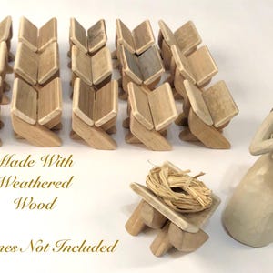 May include: Wooden nativity scene set with weathered wood book-shaped stands. Includes a figurine of a woman holding a baby, and a manger with a straw nest. The text reads "Made With Weathered Wood" and "Figurines Not Included".