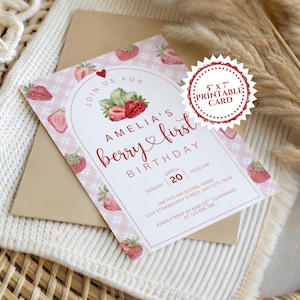 May include: A printable 5" x 7" birthday card with a strawberry theme. The card features the text "Amelia's first berry birthday" in a whimsical font, surrounded by strawberry illustrations and a pink gingham pattern. Includes RSVP information.