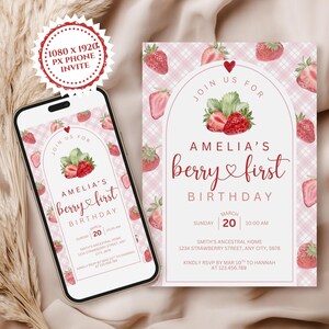 May include: A digital invitation for a first birthday, featuring a strawberry theme. The design includes a smartphone displaying the invitation and a printed card. The invitation reads "Amelia's berry first birthday" with details.
