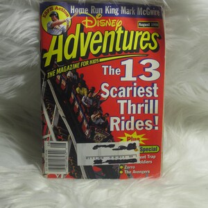 May include: A red and white Disney Adventures magazine cover featuring a roller coaster ride with the text "The 13 Scariest Thrill Rides!" and "Plus Special Tent Trap Soldiers, Zorro, The Avengers".