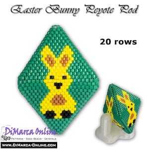 May include: A green, yellow, and brown beaded Easter bunny charm with 20 rows of beads. The charm is shaped like a diamond and is displayed on a white stand. The text "Easter Bunny Peyote Pod" and "20 rows" is visible in the image.