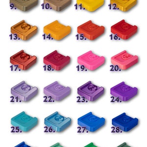 May include: Thirty-three 3D printed plastic squares in various colors, numbered 1 through 33. The squares are all the same size and shape, and they are arranged in rows of four. The squares are all different colors, including white, gray, black, brown, yellow, orange, red, pink, purple, blue, green, and olive.