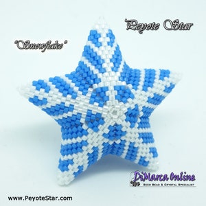 May include: A handcrafted, five-pointed star ornament, intricately beaded in a snowflake pattern. The star features a combination of white and blue beads. The text "Snowflake" is above the star, and "Peyote Star" is above the star.