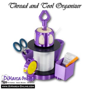 May include: A purple thread and tool organizer with a spool of white thread, scissors, and a small container. The organizer has a handle and a needle holder. The text "Thread and Tool Organizer" is at the top.