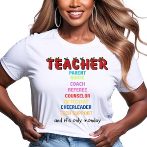 May include: White t-shirt with the word "TEACHER" in red, green, and black lettering. Below, the shirt lists other roles: Parent, Nurse, Coach, Referee, Counselor, Detective, Cheerleader, and Tech Support. The phrase "and it's only monday" is at the bottom.