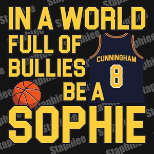 May include: A black graphic design featuring the yellow text IN A WORLD FULL OF BULLIES BE A SOPHIE. An orange basketball is positioned on the left, and a dark blue basketball jersey with yellow trim, the name CUNNINGHAM, and the number 8 is on the right.