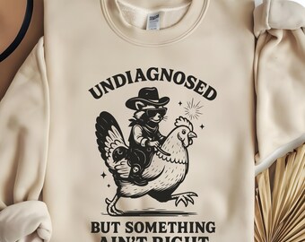Undiagnosed But Something Ain’t Right SVG PNG, Funny Cowboy Raccoon Chicken SVG, Adult Humor Shirt, Sarcastic Shirt, Funny Sarcasm Raccoon