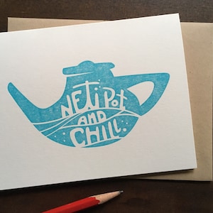 May include: A blue neti pot with the text "Neti Pot and Chill" printed on it. The image is a greeting card with a white background.