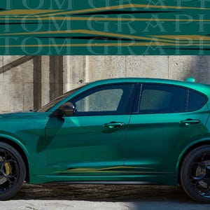 May include: A green SUV with black wheels and gold brake calipers. The car has a gold and black graphic design on the side. The background features the text "CUSTOM GRAPHICS" in white and gold.