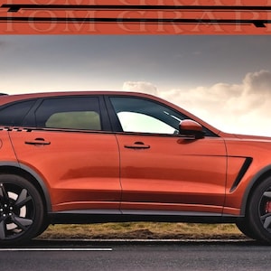 May include: A bright orange SUV with black racing stripes on the side. The car has black wheels and a black grille.