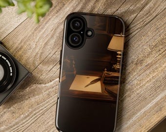 May include: A smartphone case featuring a printed image of a dark wooden desk with a lamp, a stack of books, and a single quill pen resting on a piece of paper. The case has a black frame and a dual-lens camera cutout at the top left corner.