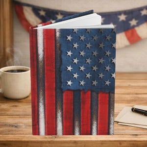 May include: A hardcover journal featuring a weathered American flag design on the front cover. The cover displays vertical red and white stripes alongside a blue field with white stars, all rendered with a distressed, textured appearance.