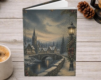 May include: A hardcover book featuring a winter village scene on the cover, depicting a stone bridge over a river, snow-covered houses, a church steeple, and a lit street lamp decorated with a red bow under a cloudy sky.