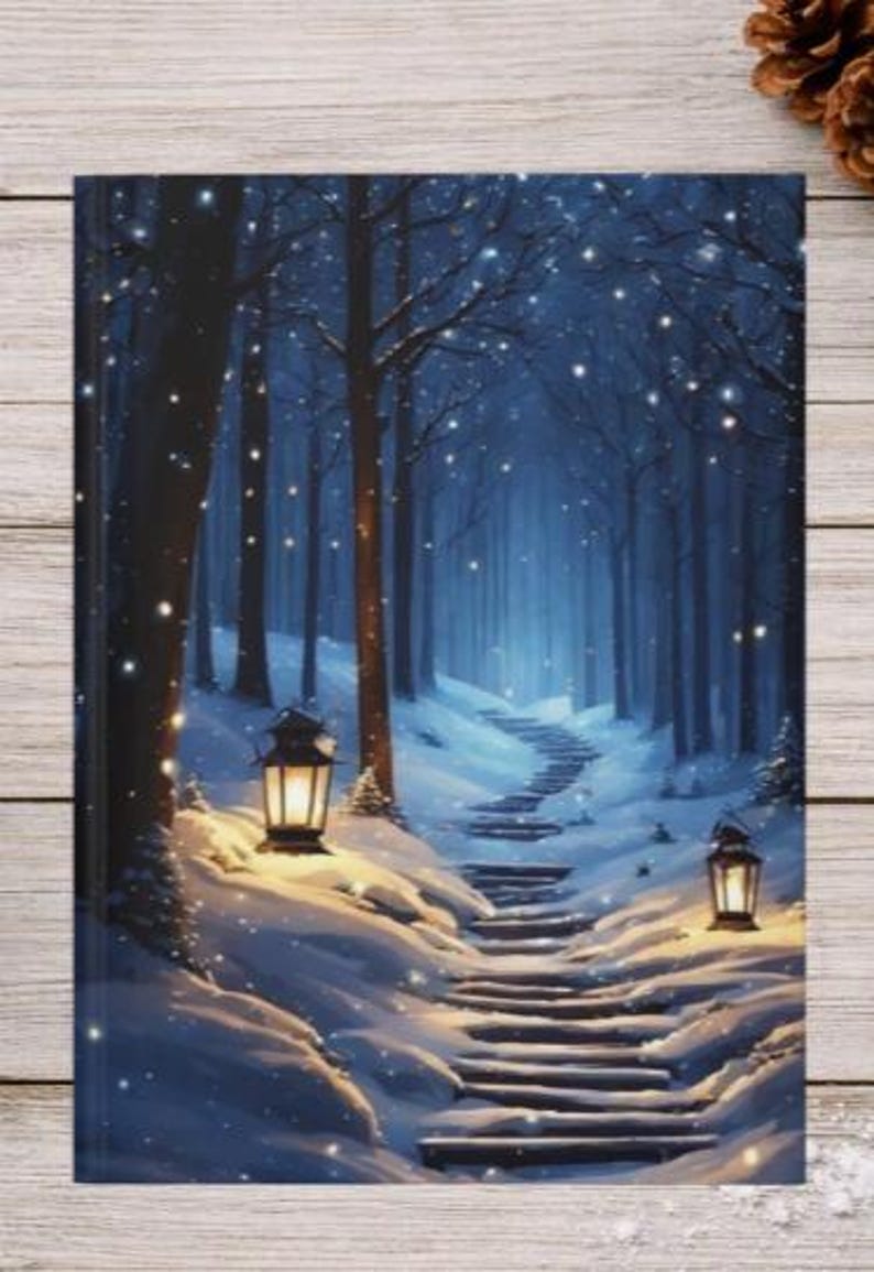 May include: A rectangular notebook cover featuring a snowy forest scene at night with a winding stone staircase leading into the dark trees. Two glowing lanterns illuminate the snow-covered path, while soft white light specks fall throughout.
