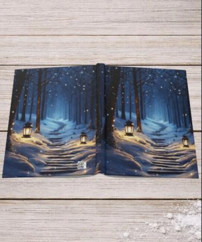 May include: A hardcover book featuring a wrap-around illustration of a snowy forest path at night. The scene depicts dark trees, a winding staircase covered in snow, and glowing lanterns emitting warm light against the cool blue winter atmosphere.