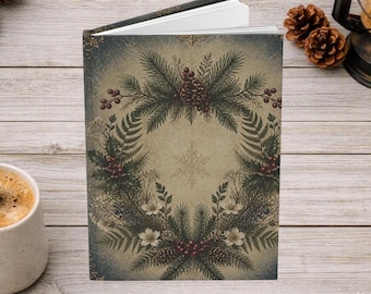 May include: A hardcover journal featuring a vintage-style illustration of a wreath made of pine branches, red berries, and white flowers on a beige background with a central snowflake motif and dark blue edges.