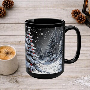May include: A black ceramic mug featuring a winter scene with snow-covered pine trees, red ornaments on the foreground tree, and a starry night sky. The mug has a large handle and a smooth finish, displaying a detailed graphic of a snowy forest.
