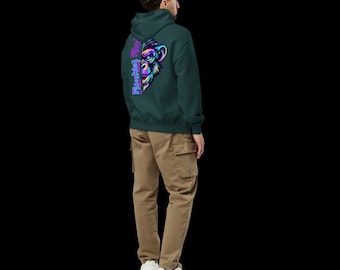 May include: A dark green hooded sweatshirt featuring a vibrant neon-colored graphic of a monkey face on the back, accompanied by the vertical text "Monkey" in a stylized purple font. The hoodie is paired with tan cargo pants and white sneakers.