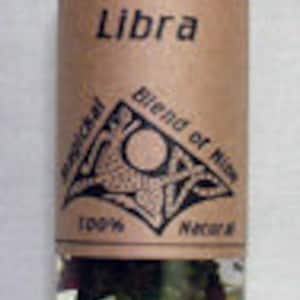 May include: A small glass bottle with a black lid filled with dried herbs. The label reads "Libra Blend of Herbs 100% Natural".