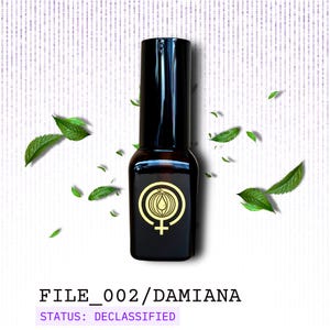 May include: A dark brown bottle with a black cap and a gold emblem featuring a circle with a cross and a symbol inside. The text "FILE_002/DAMIANA" and "STATUS: DECLASSIFIED" are printed below the bottle. Green leaves are scattered around the bottle.