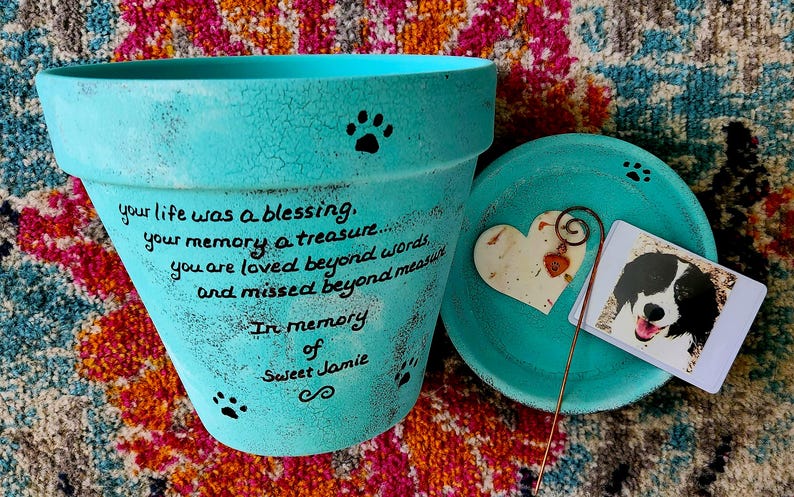 hand painted pet loss garden planter memorial with personalized wording and pets name.  shown in turquoise.