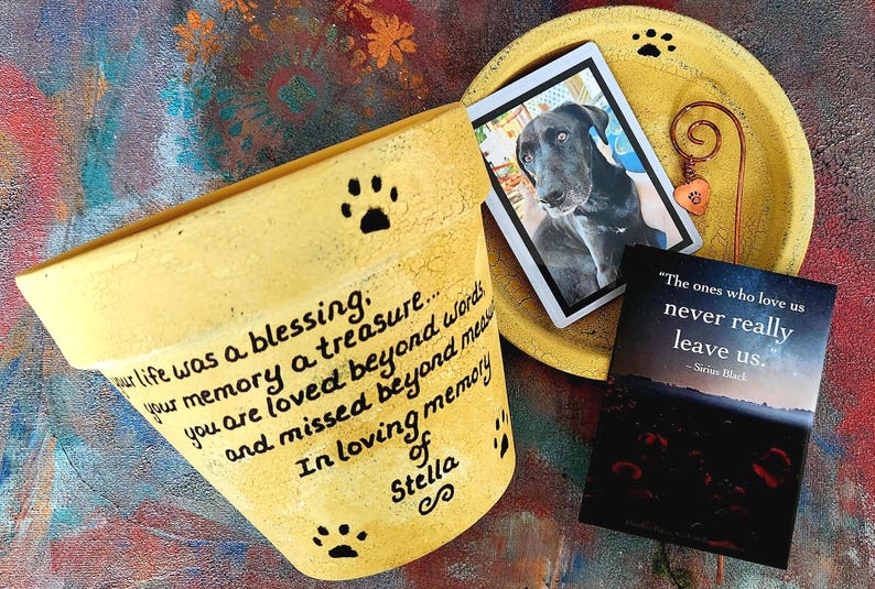Hand-painted personalized pet memorial planter with custom wording and colors. Terracotta sympathy pot with pet name for dog or cat loss, Rainbow Bridge tribute. Shown in yellow.
