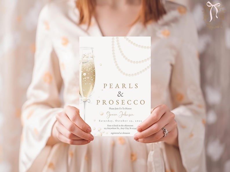 May include: A white invitation card with gold lettering that reads "Pearls & Prosecco" and features a glass of champagne with pearls. The invitation is for a party for Grace Johnson on Saturday, October 22nd.