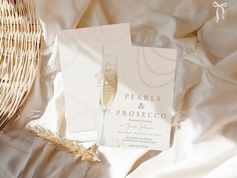 May include: A white invitation card with gold lettering that reads "Pearls & Prosecco". The invitation is for a party on Saturday, October 29, 2021, for Grace Johnson. The card is decorated with a pearl necklace and a glass of champagne.