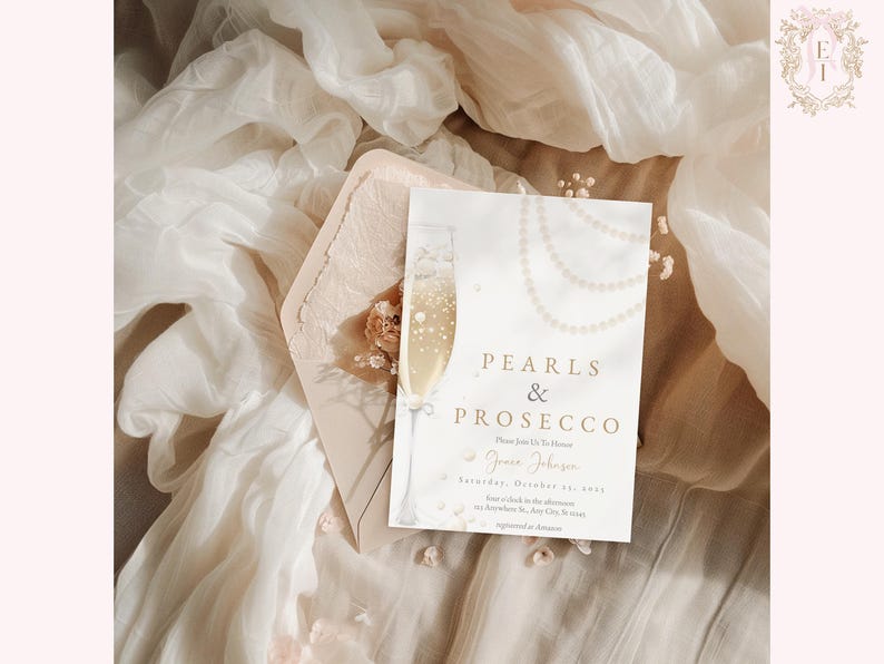 May include: A white invitation card with gold lettering that reads "Pearls & Prosecco". The card features a watercolor illustration of a champagne flute and a pearl necklace.