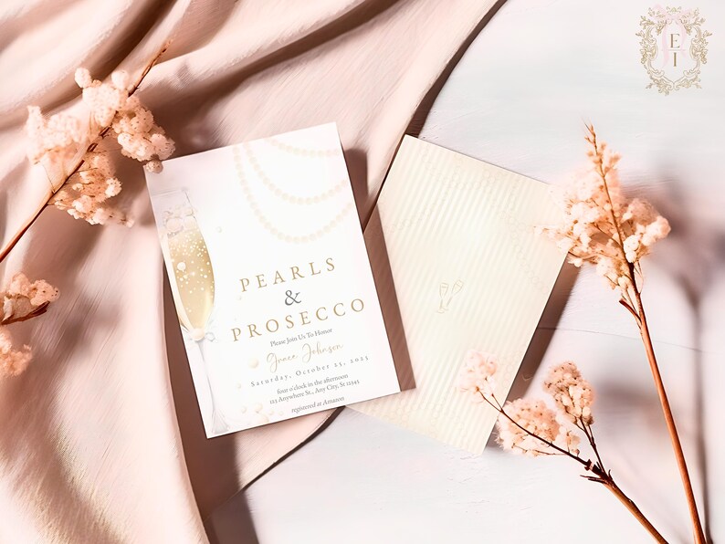May include: A white invitation card with gold lettering that reads "Pearls & Prosecco". The card features a champagne flute with pearls and a floral design. The invitation is for a party on Saturday, October 29th.