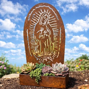 May include: A weathered metal garden art piece featuring a cut-out design of the Virgin Mary. The artwork is set in front of a blue sky with white clouds and a rectangular planter box filled with succulents.