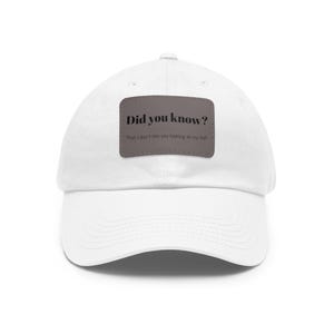 May include: A white baseball cap with a curved peak. A rectangular patch on the front displays the text "Did you know?" above the phrase "That I don't like you looking at my hat."