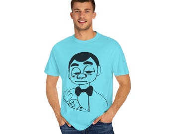 May include: A light blue t-shirt with a black and white illustration of a person wearing a bow tie. The person has a serious expression and is looking to the side.