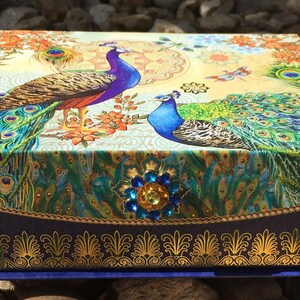 Luxury Natural Perfume Gift Set: Floral Aromatherapy - Sovereign Collection. A decorative box with a peacock design. The box is adorned with a jewel-encrusted floral embellishment.