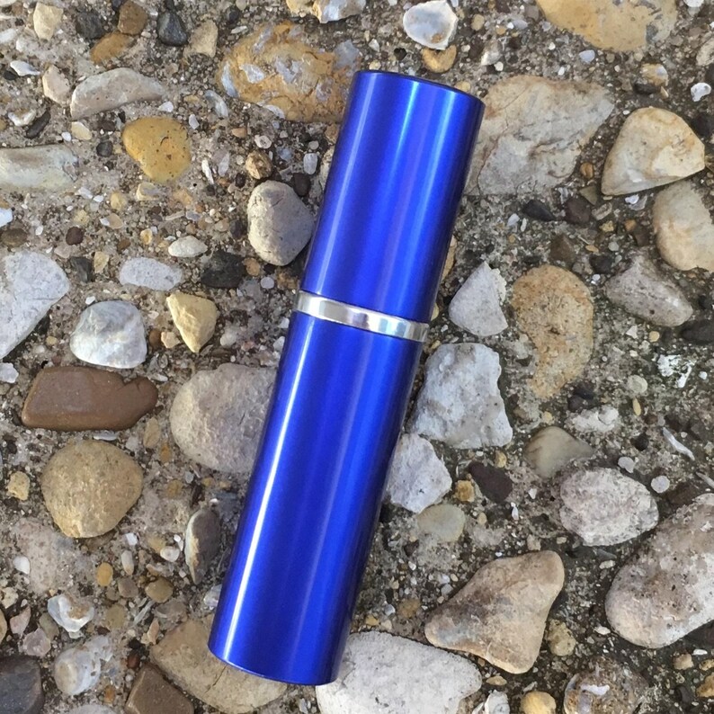 A royal blue travel sprayer. Luxury Natural Perfume Gift Set: Floral Aromatherapy - Sovereign Collection by JoAnne Bassett Perfume.
