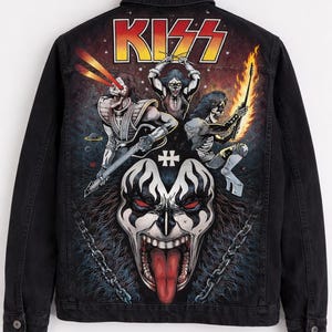 May include: Black denim jacket featuring a colorful graphic of the rock band KISS. The design includes the band's logo and illustrations of the band members in their iconic makeup and costumes. The jacket has a button-up front and two chest pockets.