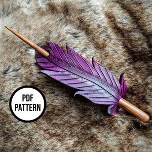 May include: A purple leather feather hair stick with a wooden handle. The hair stick is on a brown fur background. The text "PDF PATTERN" is on a white circle with a black border.