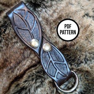 May include: Dark brown leather strap with leaf design, metal studs, and a silver ring. The strap has a detailed leaf pattern and the text "PDF PATTERN" in a white circle.