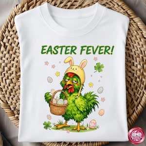 May include: White t-shirt with a green cartoon chicken wearing a yellow bunny hat and holding a basket of Easter eggs. The text "EASTER FEVER!" is above the chicken. The design includes small chicks, flowers, and clovers.
