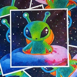 May include: Square print featuring a cartoon alien with large eyes, green and blue skin, and orange accents. The alien is seated on a colorful planet against a starry night sky. The artwork is surrounded by a white border.