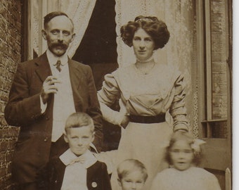 Vintage Photograph, Backyard, Family Portrait, Father Smoking, Mother looking Glamorous, Blurred Child.