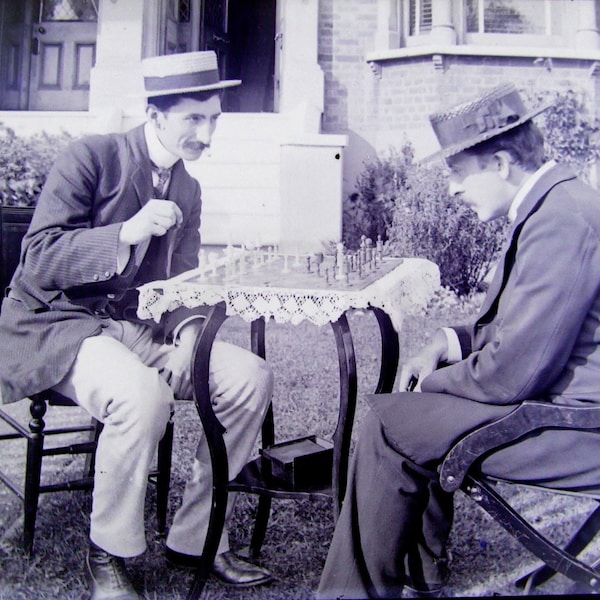 Reprint of A Vintage Edwardian Glass Negative of 2 Dapper Gents in Hats Playing Chess on A Table In the Front Garden 6x4"