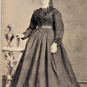 Antique CDV Photograph – Victorian Woman in Full Dress Beside Table, Unknown Photographer