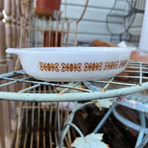 May include: White oval baking dish with a brown floral pattern around the rim.