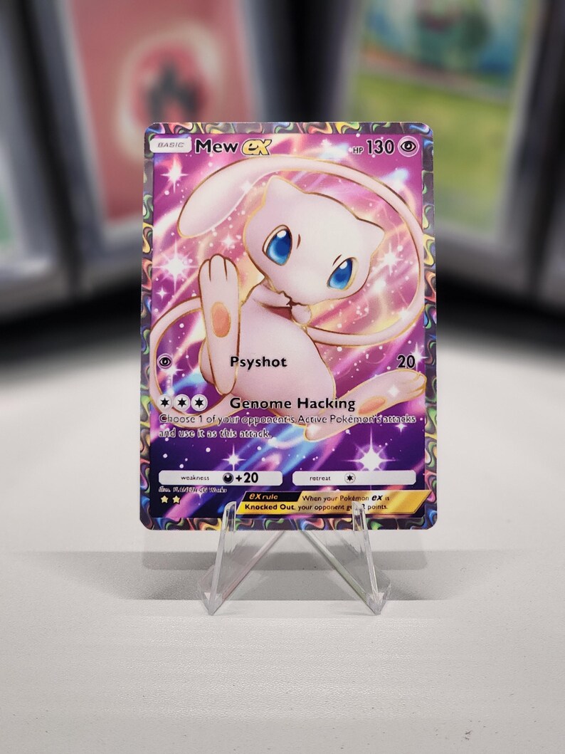May include: A pink and purple Pokemon card featuring Mew EX with a gold border. The card has a picture of Mew EX with a pink background and stars. The card has the text "Mew EX" and "HP 130" in the top right corner. The card has the text "Psyshot" and "Genome Hacking" in the bottom left corner. The card has the text "20" and "+20" in the bottom right corner.